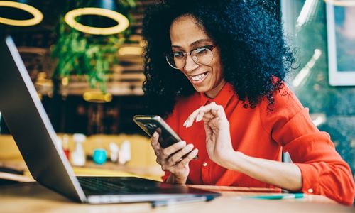 smiling woman typing on phone