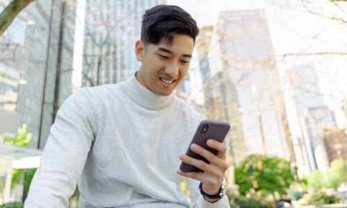 smiling man looking at his phone