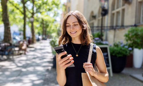 smiling woman looking at her phone