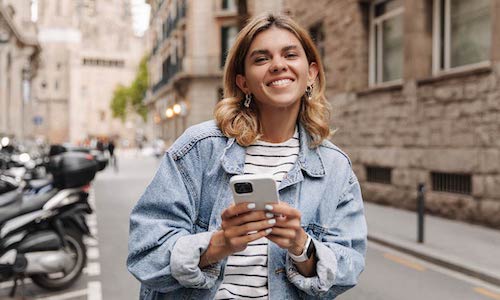 smiling woman holds a mobile phone
