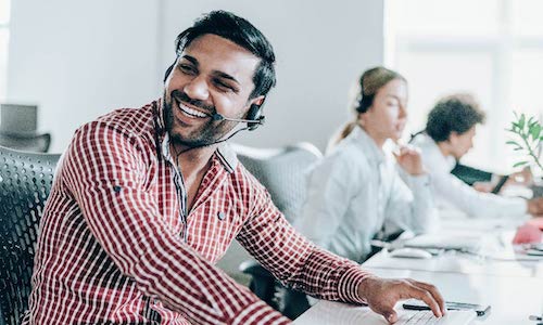 smiling man talking on the phone