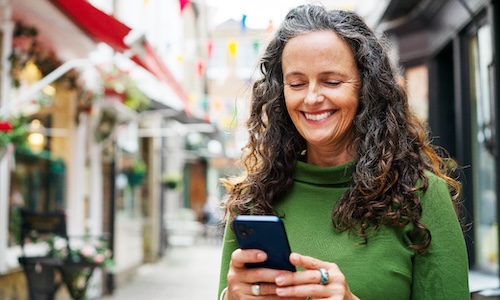 smiling woman taking an online course in her lms