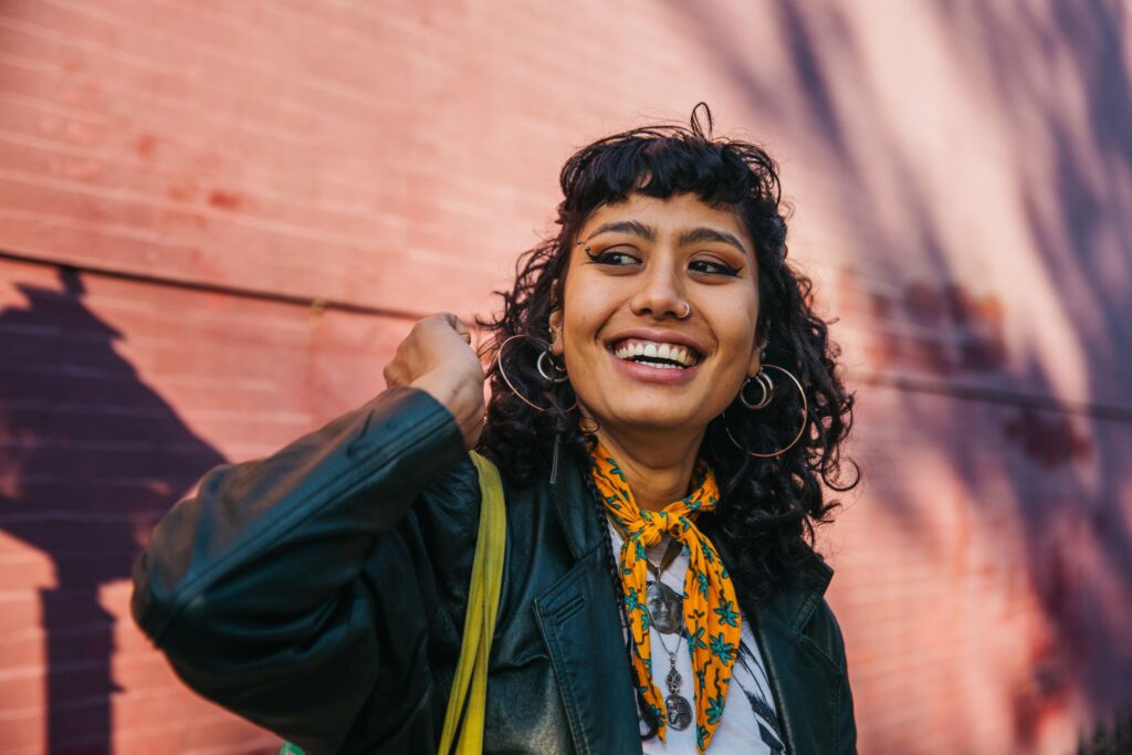 Gen Z employee feeling motivated at work. The Great Lock-in can keep employees motivated, but hustle culture mindset can lead to burnout.