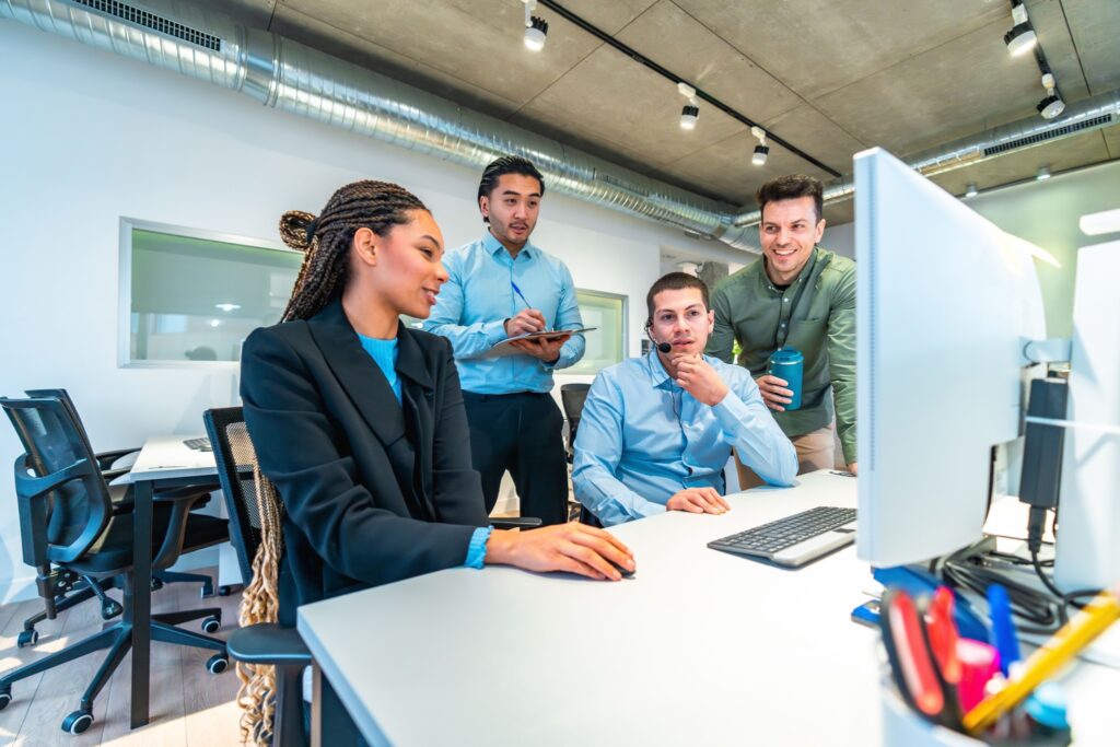 Young tech employees training on a shared desktop, using an LMS.