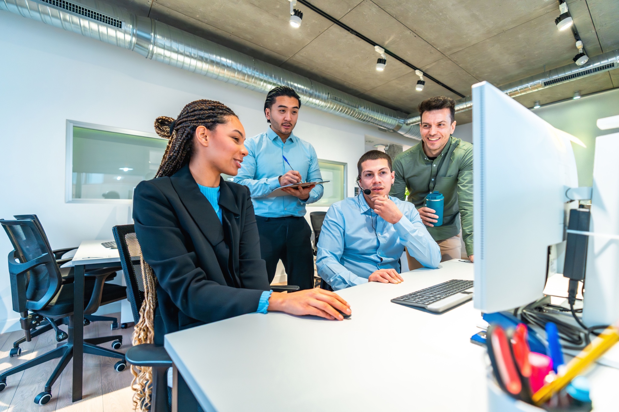 Young tech employees training on a shared desktop, using an LMS.