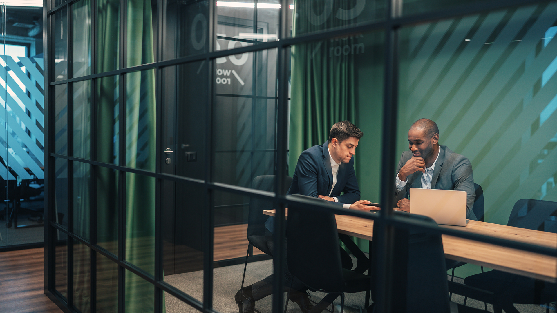 people working in a dimly lit conference room
