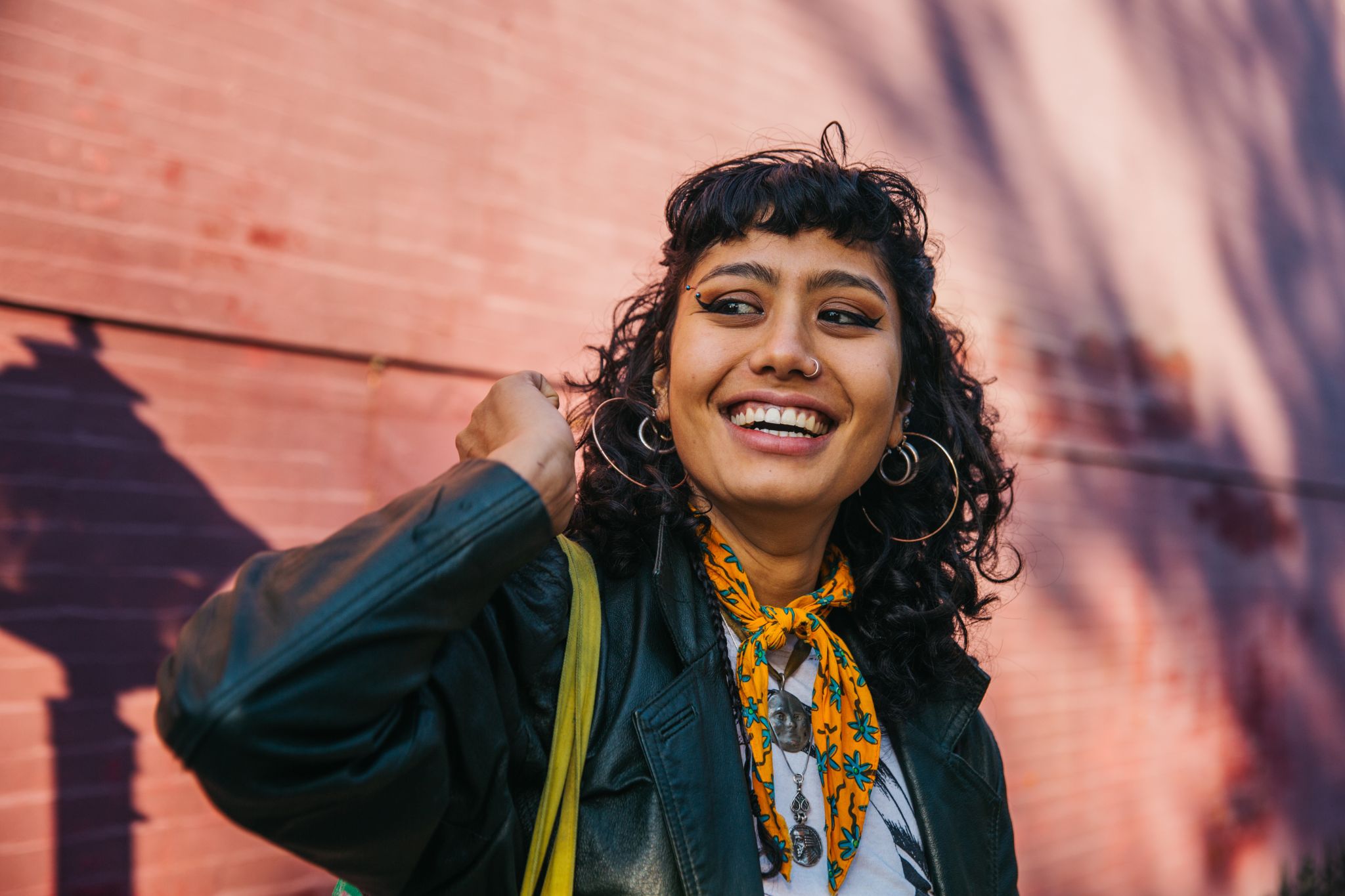 Gen Z employee feeling motivated at work. The Great Lock-in can keep employees motivated, but hustle culture mindset can lead to burnout.